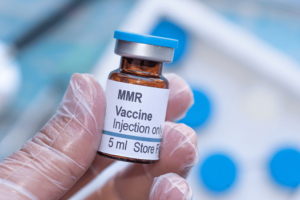 Summit Health doctor holding the measles vaccine